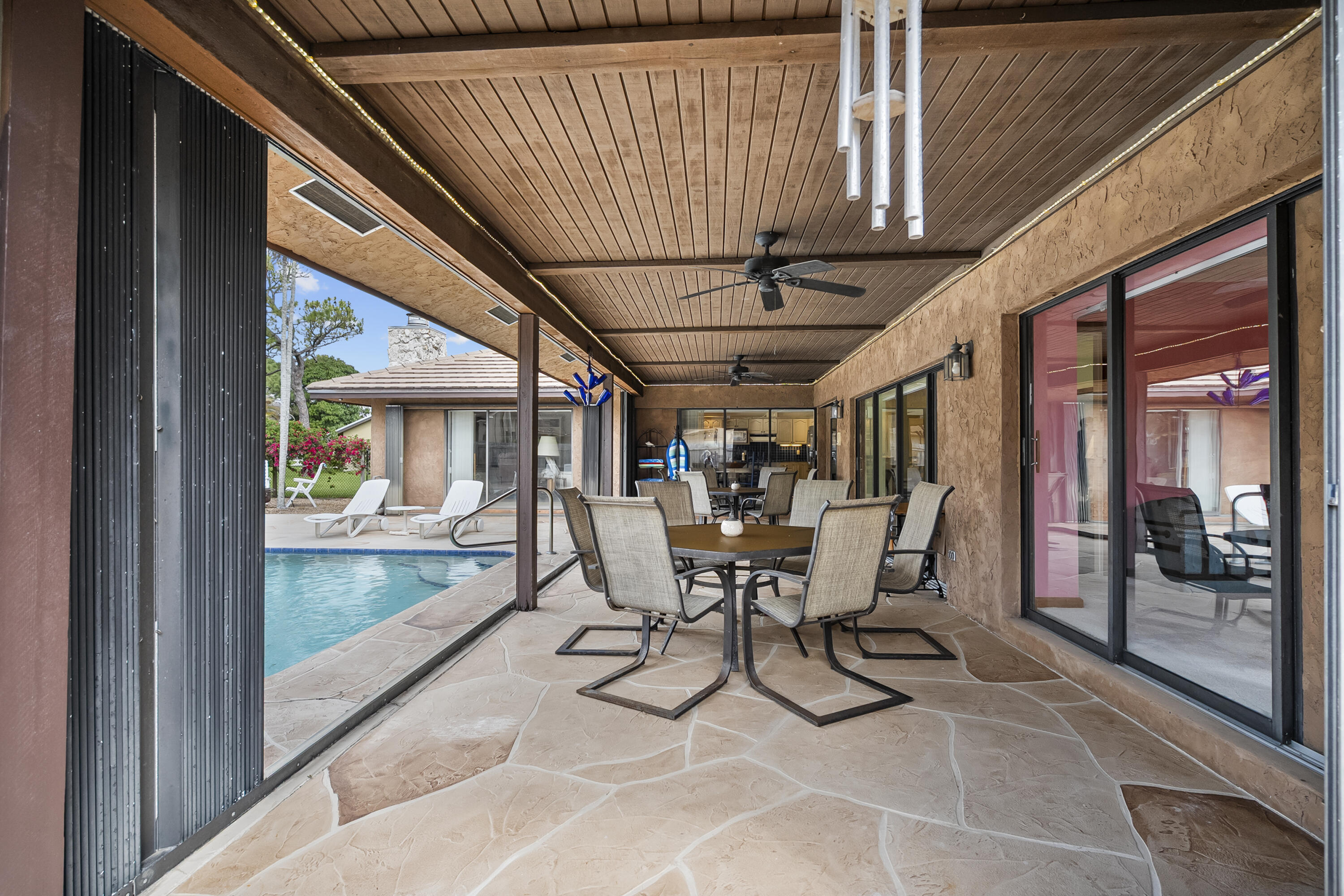 18815 South Golden Hawk Trail Jupiter, FL 33458 - Photo 8 of 49 a view of a patio with table and chairs and wooden floor