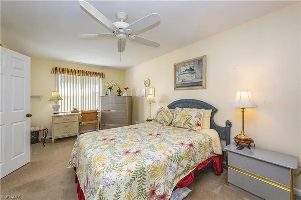 a spacious bedroom with a bed and a chandelier