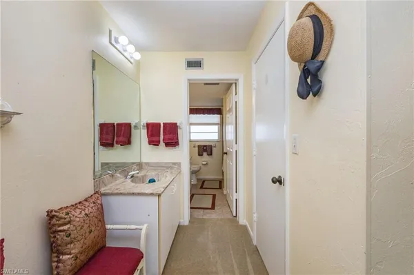 a en suite bathroom with a granite countertop sink and a mirror