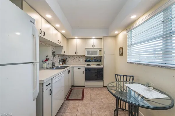 a kitchen with a sink appliances and cabinets
