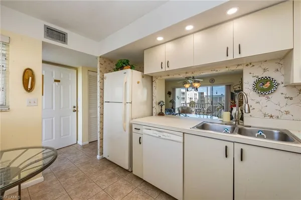 a kitchen with a sink and refrigerator