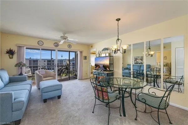 a living room with furniture and a chandelier