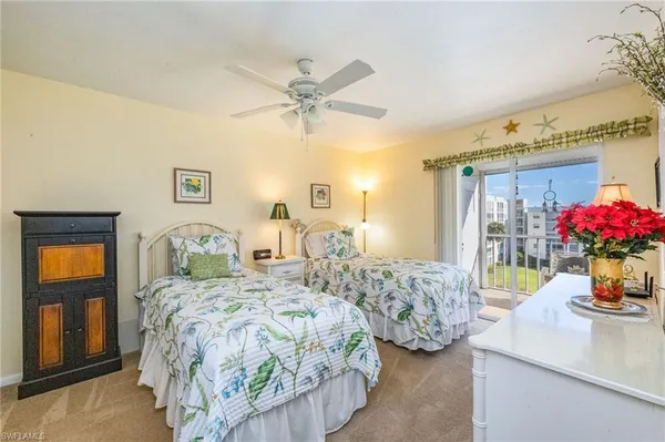 a bedroom with two beds and a chandelier