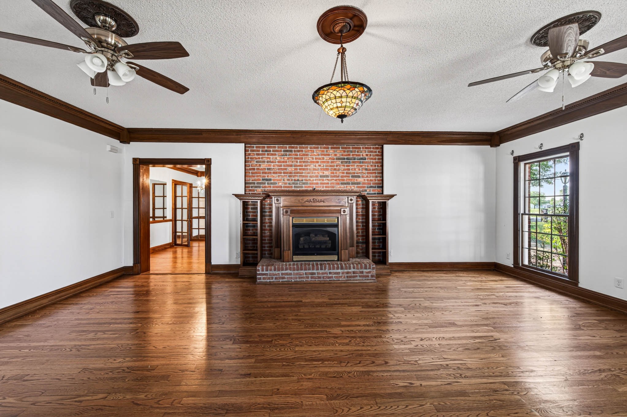 1800 Plano Road Bowling Green, KY 42104 - Photo 13 of 47 a view of an empty room with a fireplace and wooden floor