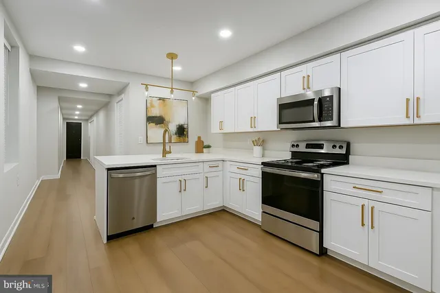 a kitchen with granite countertop white cabinets and white appliances