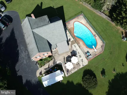 an aerial view of a house swimming pool and garden view