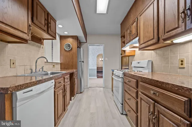 a kitchen with stainless steel appliances granite countertop a sink and cabinets