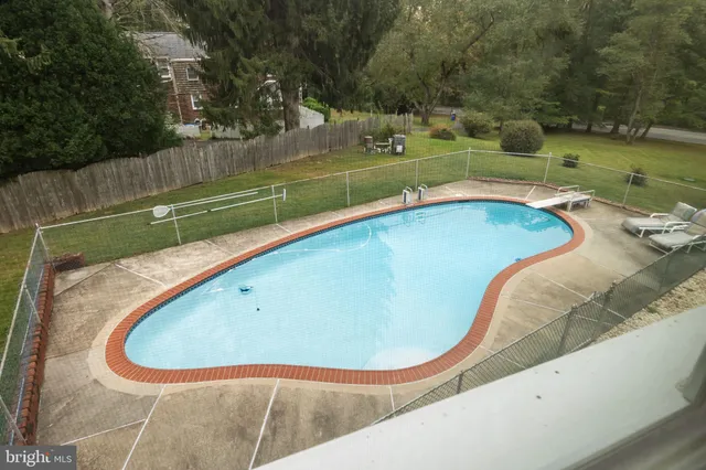 a view of a swimming pool with a yard