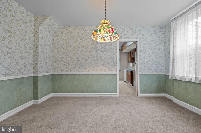 an empty room with windows and cabinet