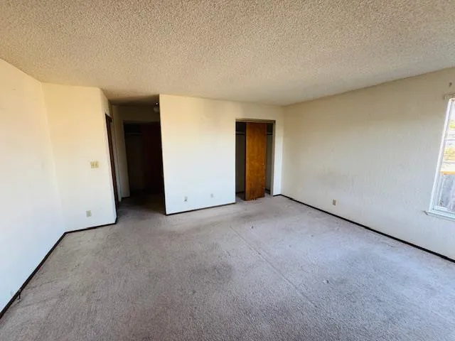 a view of an empty room and bathroom