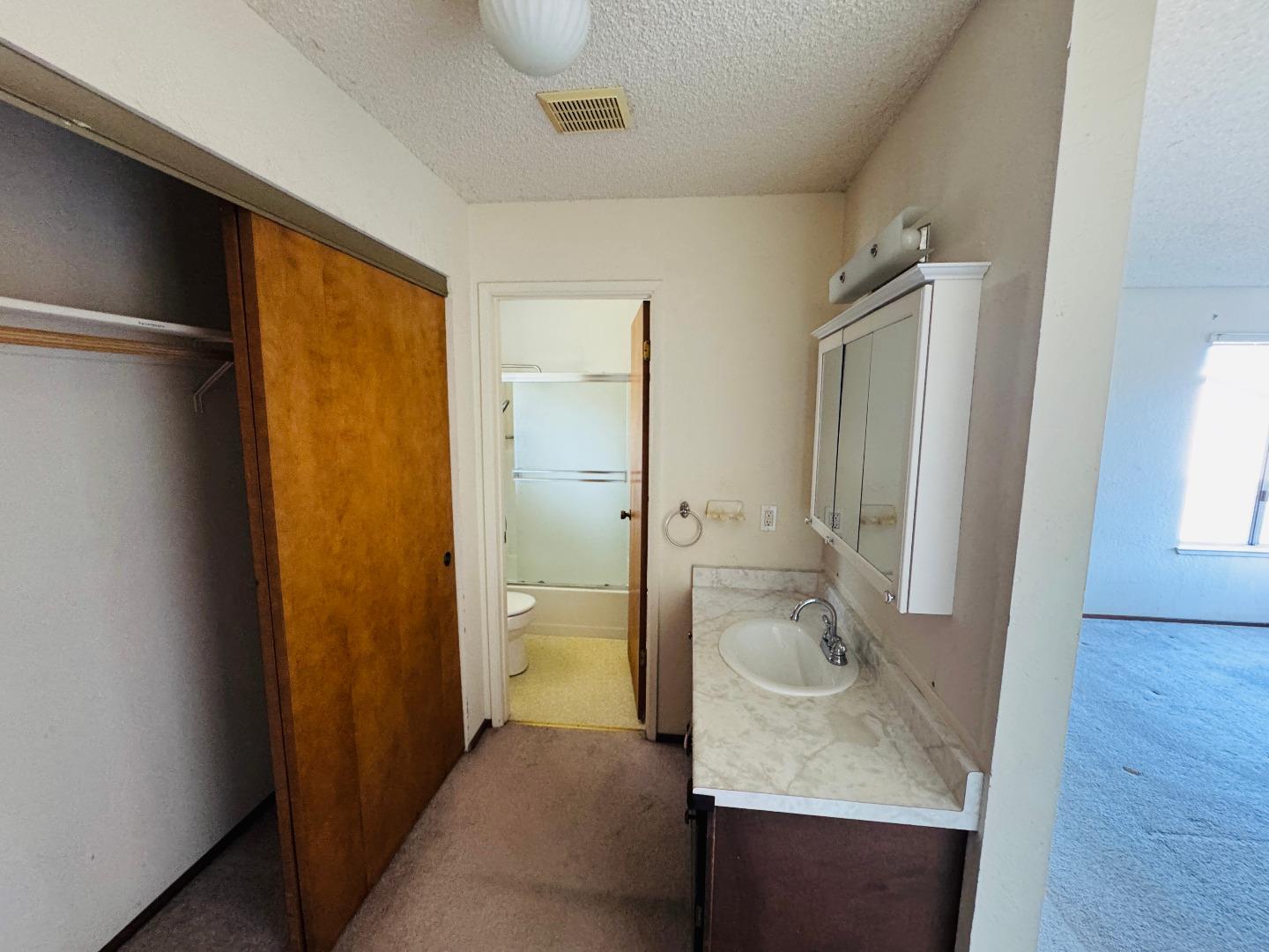3003 Crescent Street Marina, CA 93933 - Photo 9 of 20 a bathroom with a sink and mirror with toilet