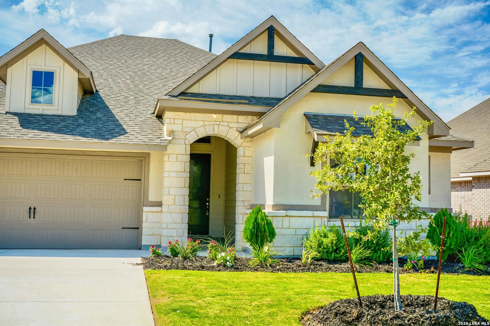 a front view of a house with garden