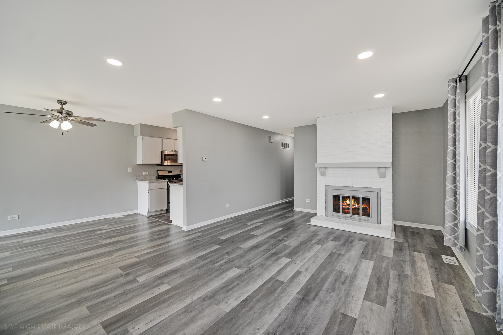 103 Red Barn Road, Unit 103 Matteson, IL 60443 - Photo 7 of 17 a view of a livingroom with wooden floor a fireplace and window