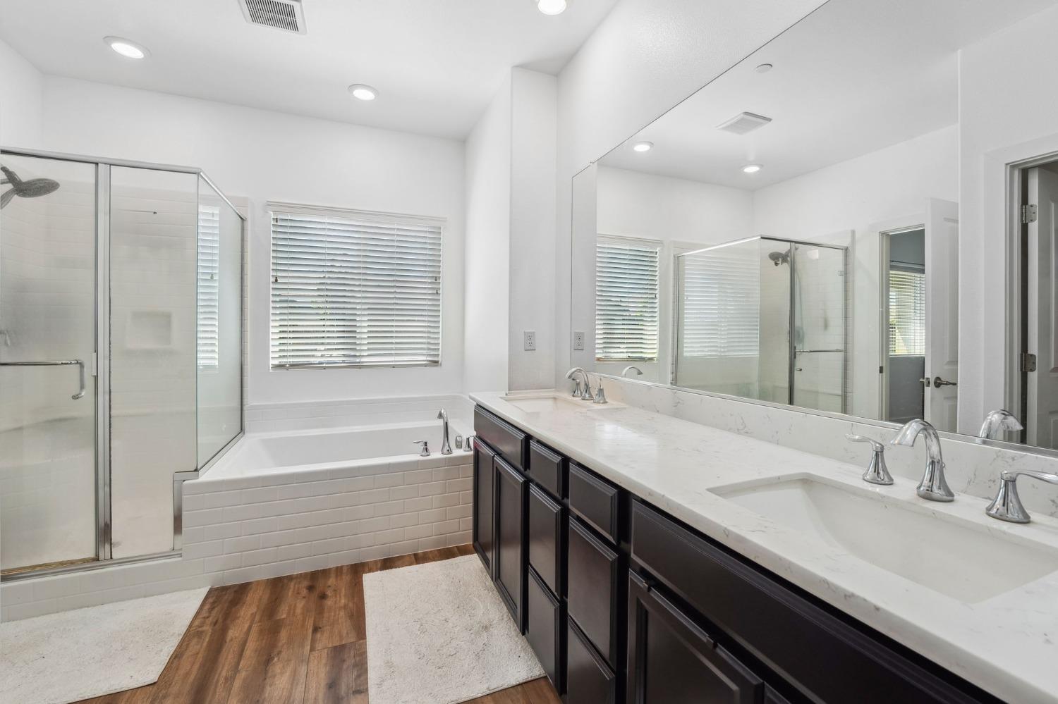 2074 Abbeylane Way Olivehurst, CA 95961 - Photo 16 of 39 a spacious bathroom with a sink double vanity granite tub shower and a mirror