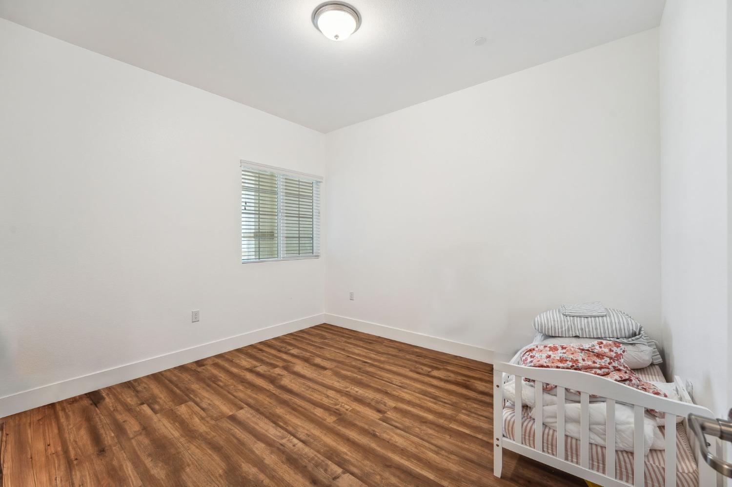 2074 Abbeylane Way Olivehurst, CA 95961 - Photo 20 of 39 a room with a bed and a window