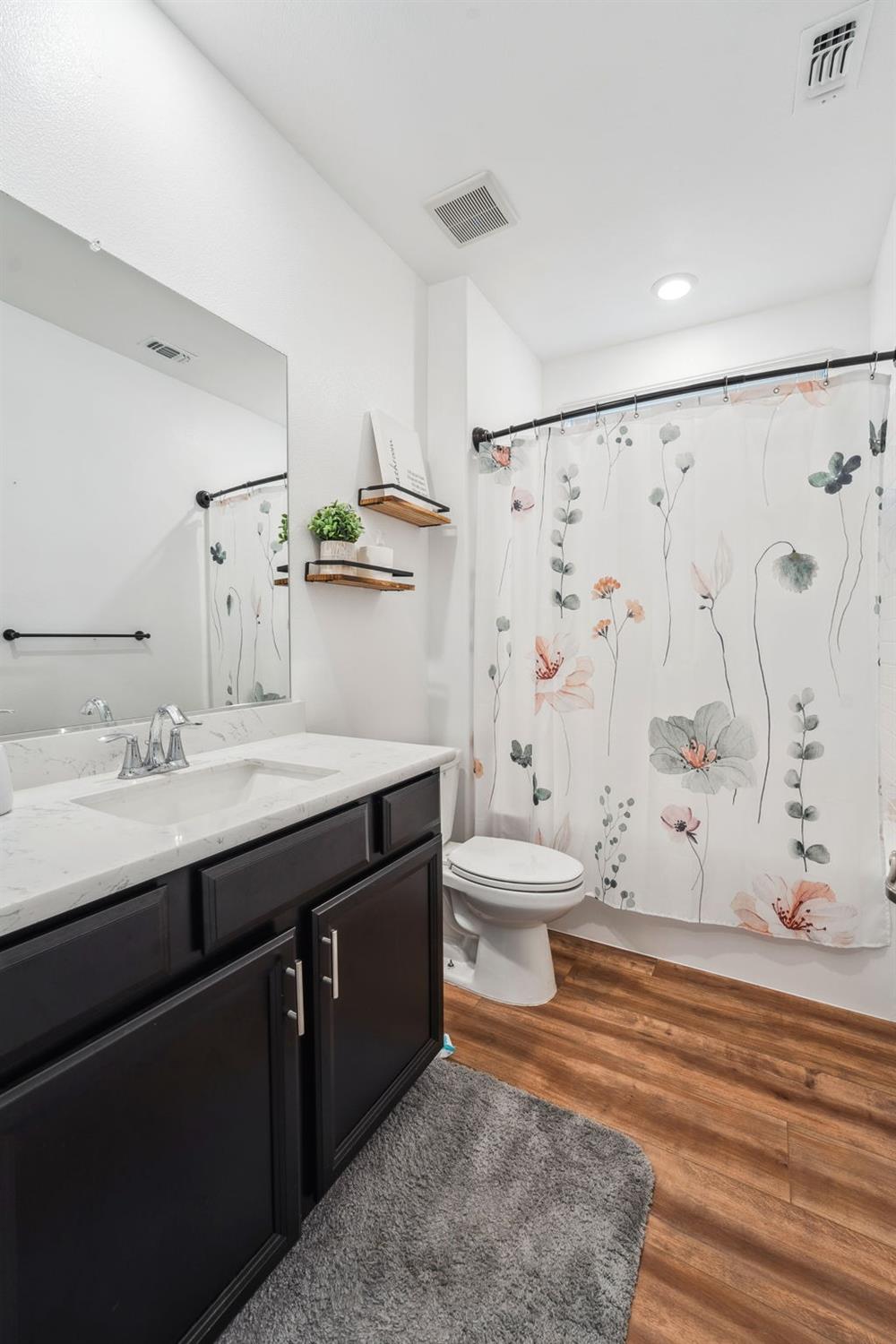 2074 Abbeylane Way Olivehurst, CA 95961 - Photo 22 of 39 a bathroom with a granite countertop sink toilet and shower