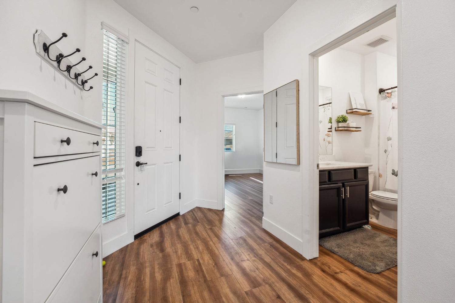 2074 Abbeylane Way Olivehurst, CA 95961 - Photo 23 of 39 a view of a hallway with wooden floor and staircase