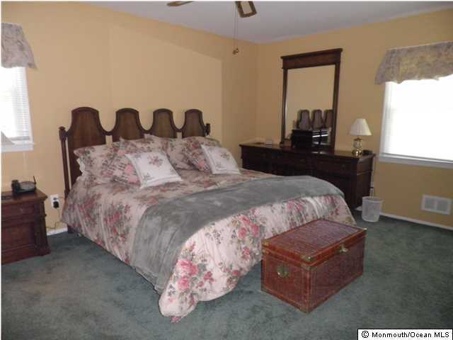 26 Turnberry Drive Lincroft, NJ 07738 - Photo 12 of 16 a large bed sitting in a bedroom next to a window