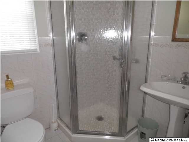 26 Turnberry Drive Lincroft, NJ 07738 - Photo 13 of 16 a bathroom with a sink a toilet and shower