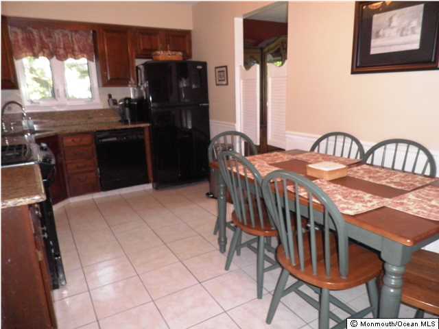 26 Turnberry Drive Lincroft, NJ 07738 - Photo 5 of 16 a kitchen with stainless steel appliances granite countertop a stove a refrigerator a table and chairs