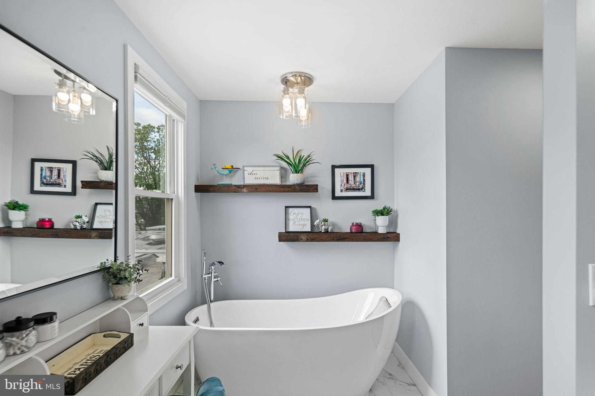 1330 South 16th Street Philadelphia, PA 19146 - Photo 23 of 37 a white bath tub sitting next to a window