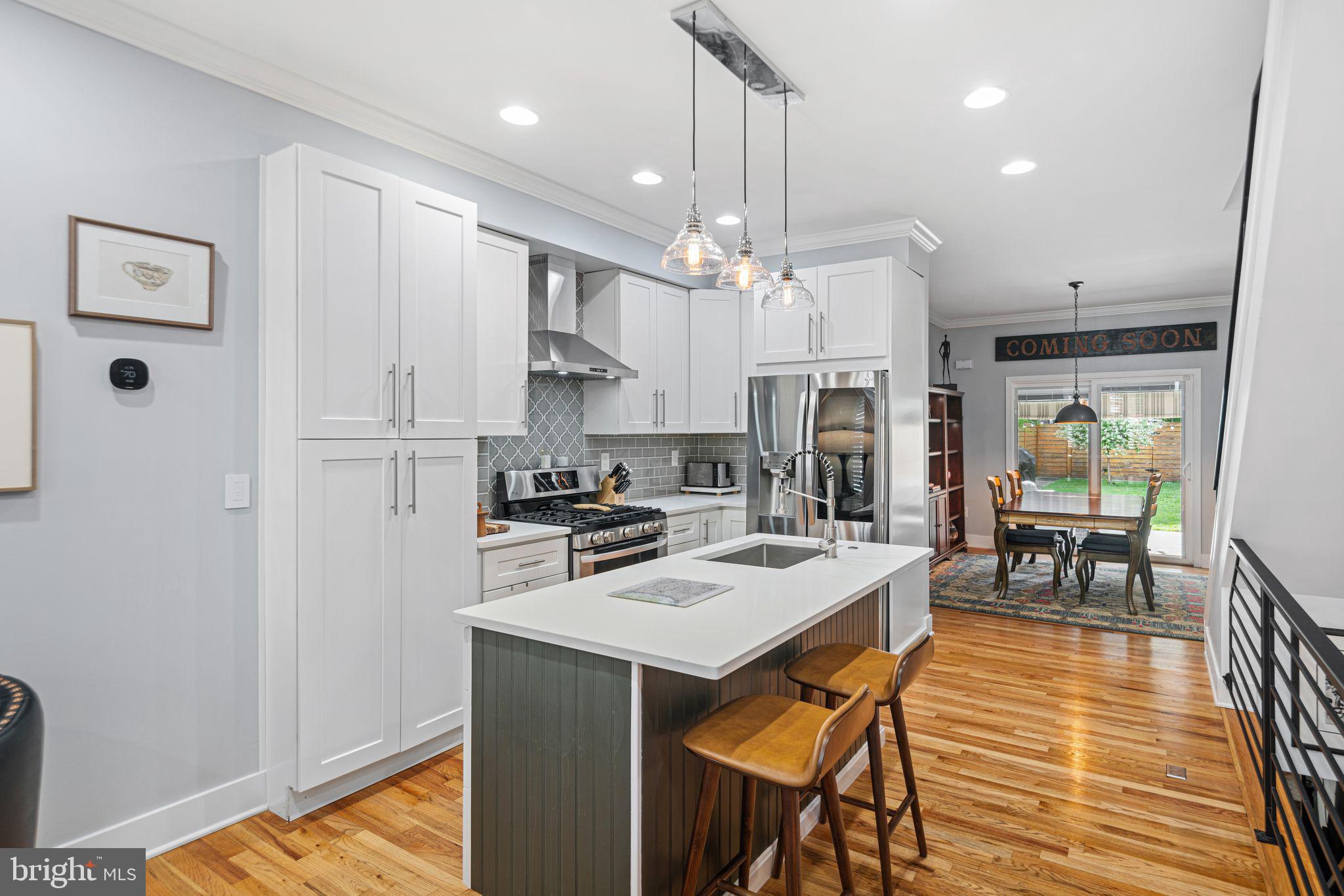 1330 South 16th Street Philadelphia, PA 19146 - Photo 3 of 37 a kitchen with stainless steel appliances granite countertop a refrigerator a sink dishwasher a stove and white cabinets with wooden floor