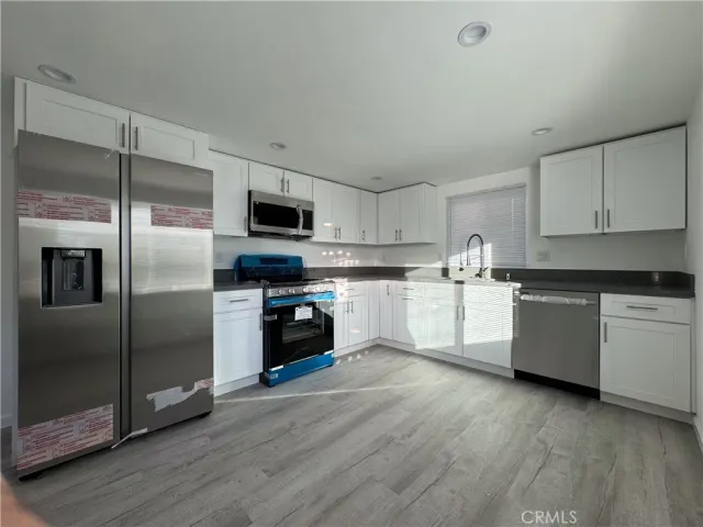 a kitchen with a refrigerator a microwave a sink and a stove