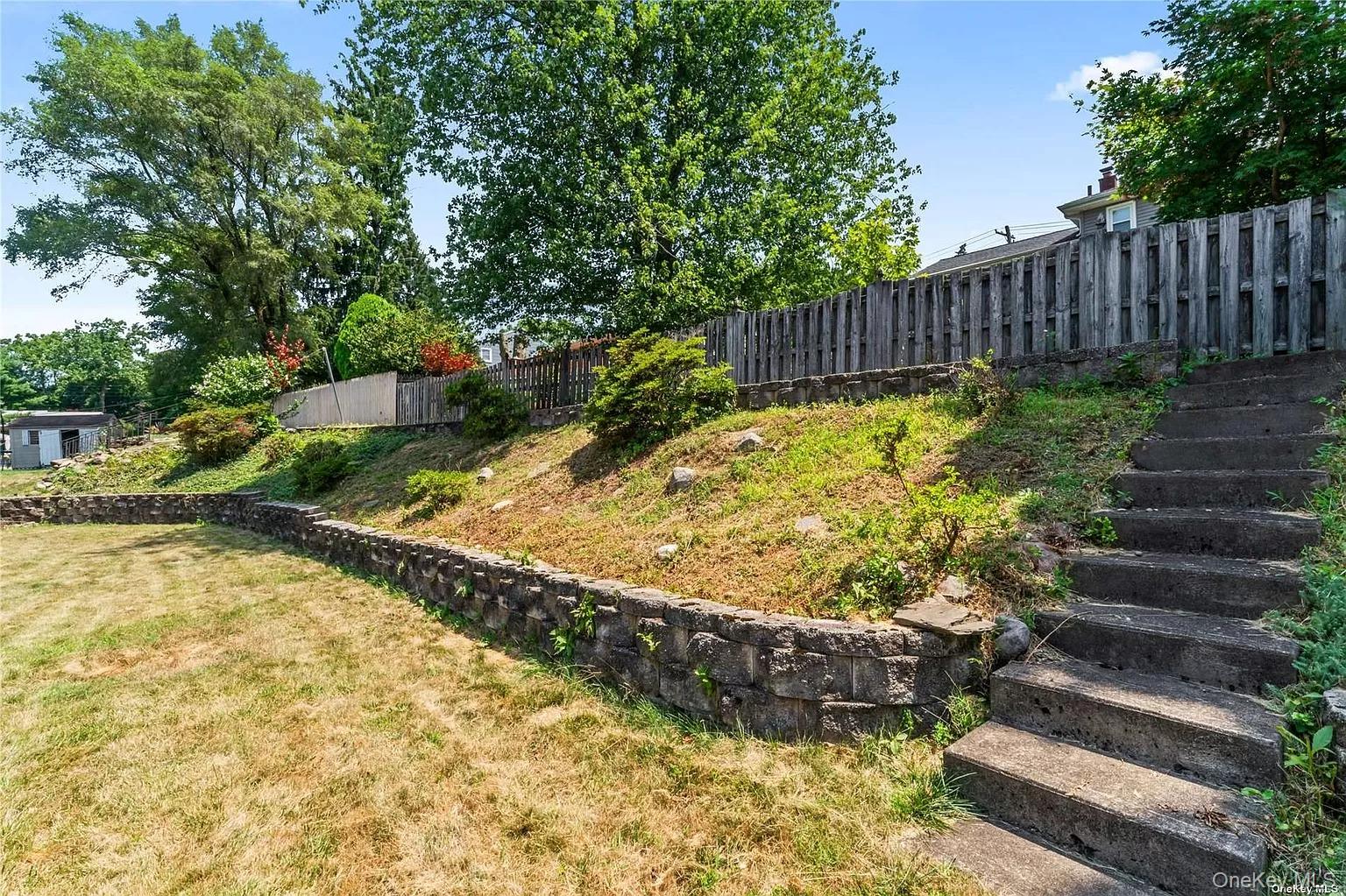 6 Valley View Terrace Suffern, NY 10901 - Photo 17 of 19 a view of a backyard with wooden fence