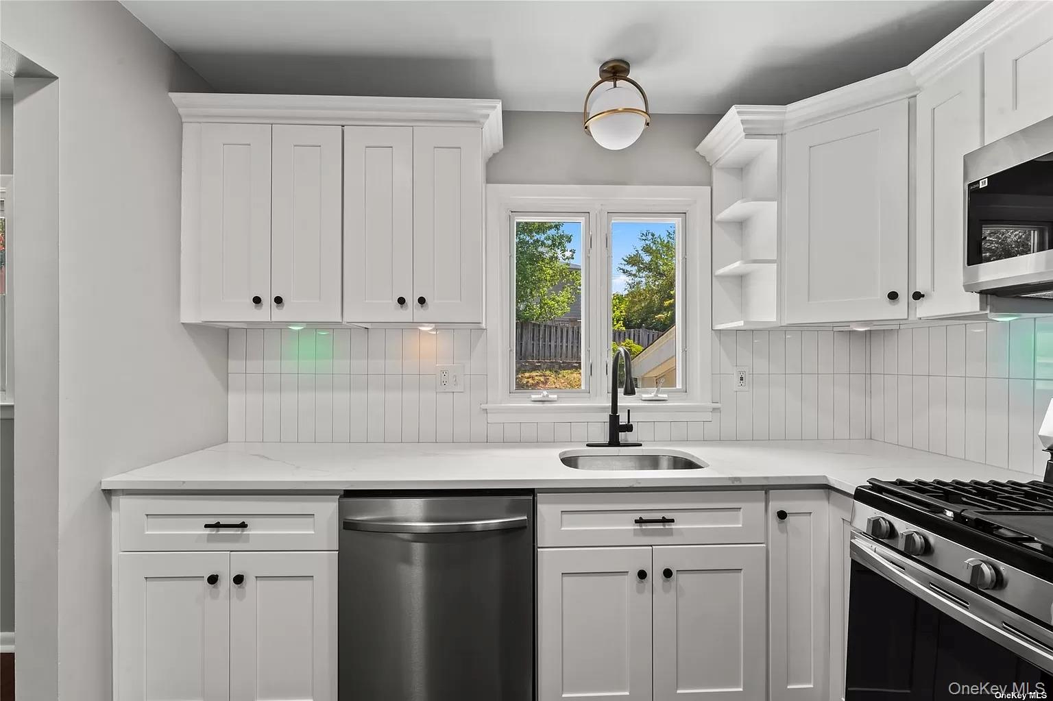 6 Valley View Terrace Suffern, NY 10901 - Photo 4 of 19 a kitchen with stainless steel appliances granite countertop a sink a stove and a microwave