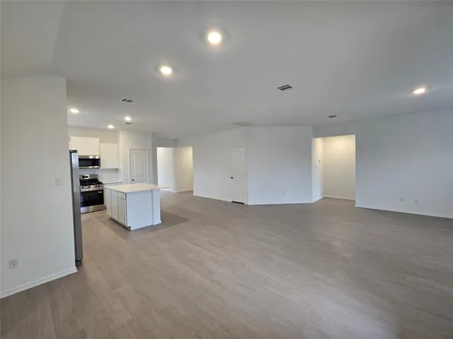 a view of a kitchen with a sink and a refrigerator
