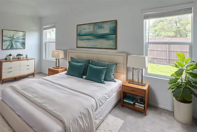 a bedroom with a bed and a potted plant