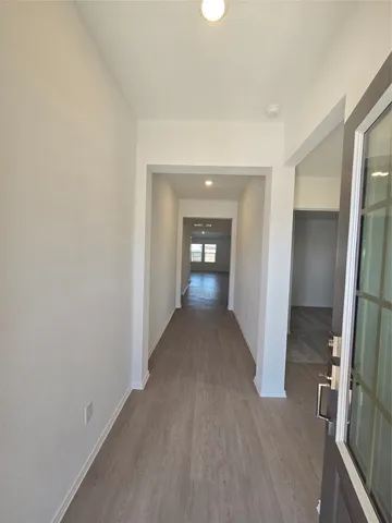 a view of entryway and hall with wooden floor