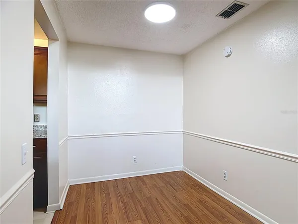 a view of a room with wooden floor