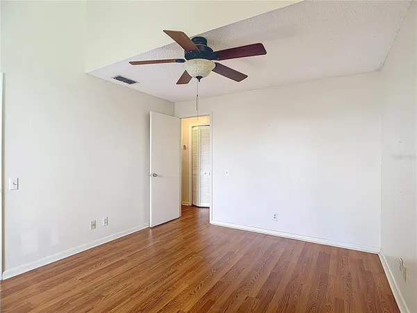 a view of an empty room with wooden floor