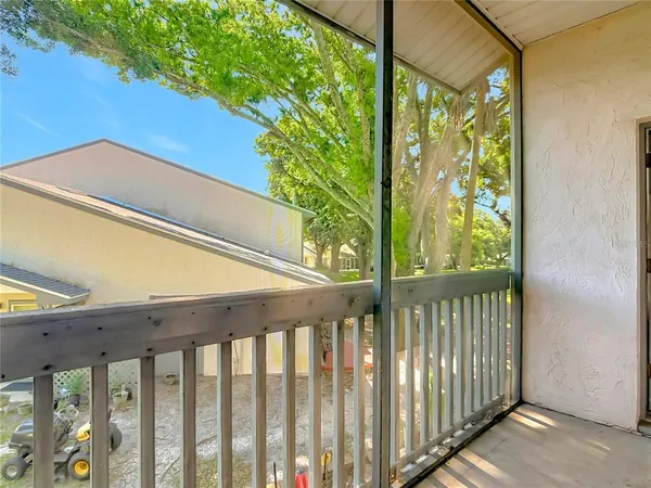 a balcony with trees in front of it