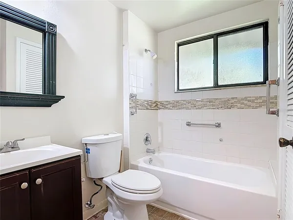 a bathroom with a sink a toilet and a mirror