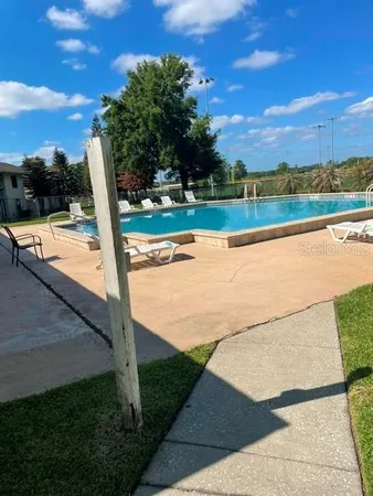 a view of a swimming pool and a yard