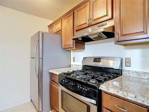 a kitchen with stainless steel appliances granite countertop a stove and a refrigerator