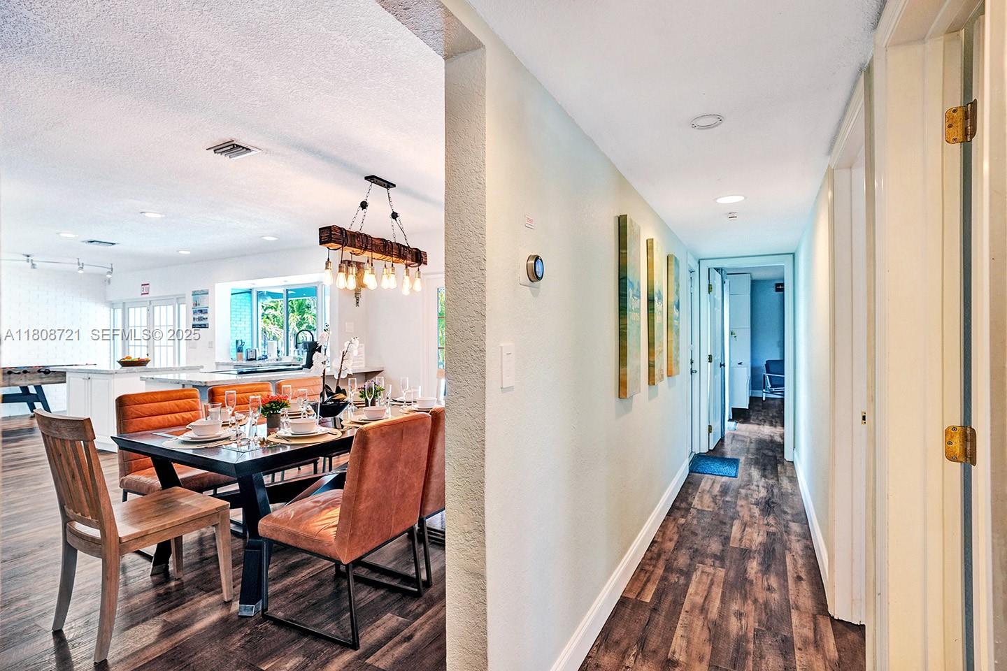 1245 Wiley Street Hollywood, FL 33019 - Photo 17 of 43 a dining room with furniture and wooden floor