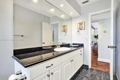 a kitchen with a sink and a refrigerator