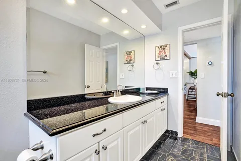 a kitchen with a sink and a refrigerator