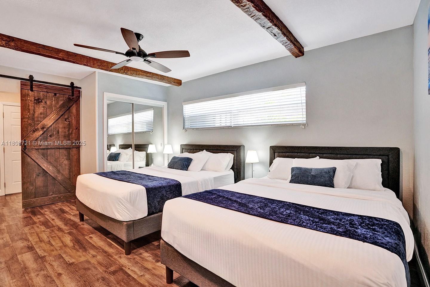 1245 Wiley Street Hollywood, FL 33019 - Photo 20 of 43 a bedroom with two beds and ceiling fan