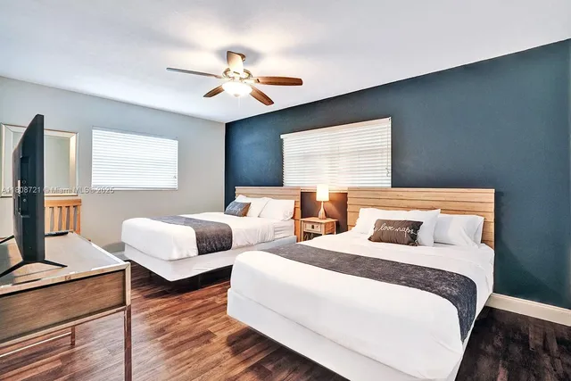 a bedroom with two beds and a chandelier