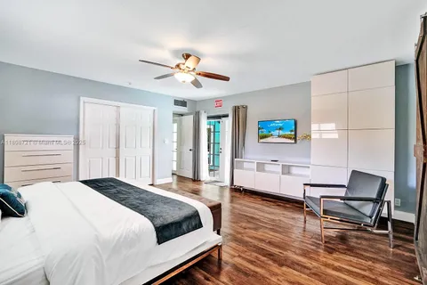 a spacious bedroom with a bed a desk and chair