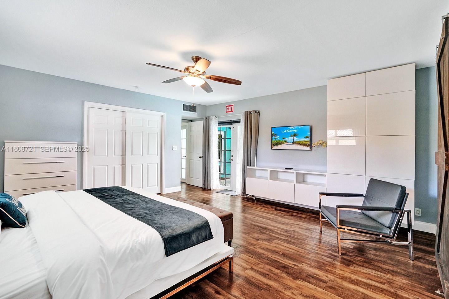 1245 Wiley Street Hollywood, FL 33019 - Photo 28 of 43 a spacious bedroom with a bed a desk and chair