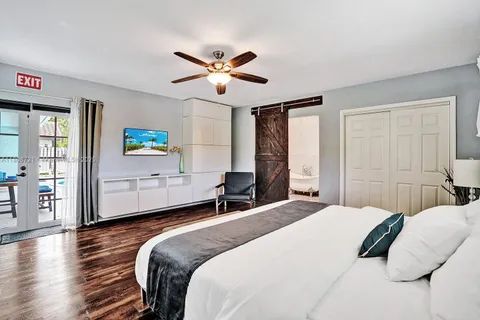 a bedroom with a large bed and a chandelier