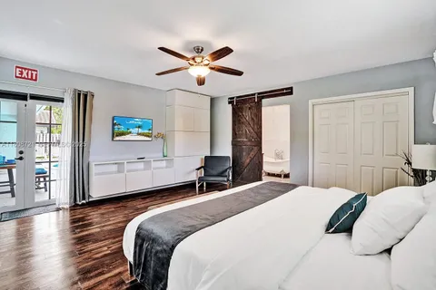 a bedroom with a large bed and a chandelier