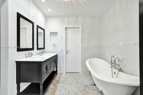 a bathroom with a sink a mirror and a bathtub