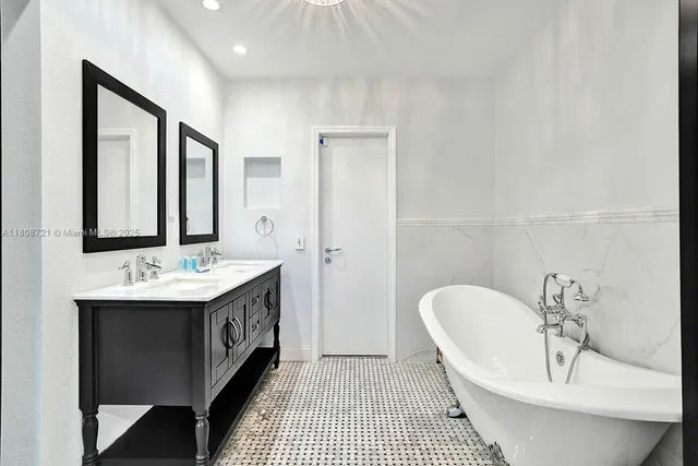a bathroom with a sink a mirror and a bathtub