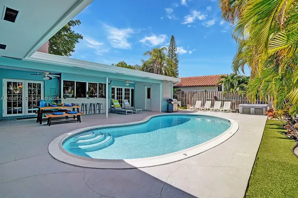a view of a house with swimming pool and sitting area